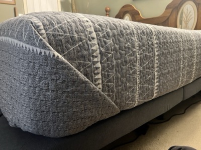 Neatly made bed with fresh linens